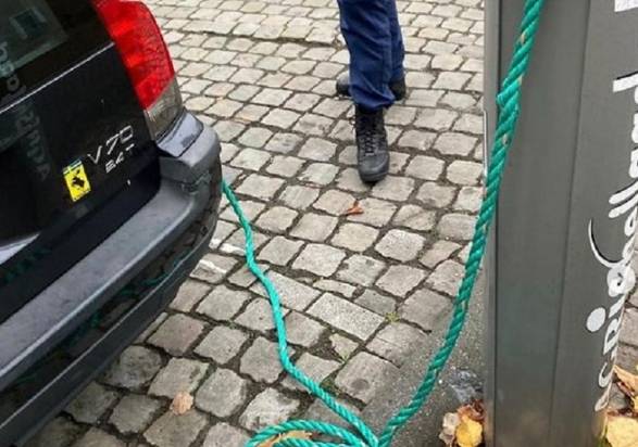 old Volvo into an electric car with a green rope